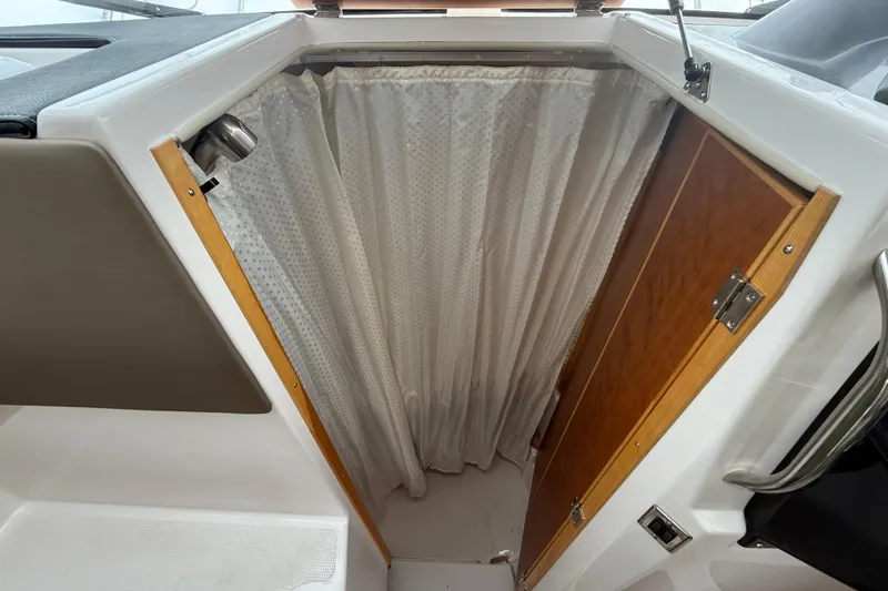 Slide: The Image of 2022 Cutwater C-24 Coupe interior with curtain and wooden door detail. - 47