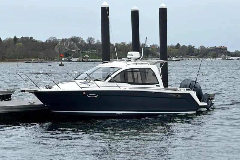 Slide: The Image of 2022 Cutwater C-24 Coupe docked on calm water. - 5