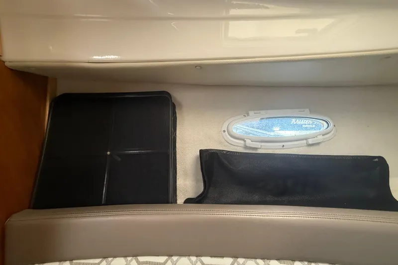 Slide: The Image of Interior view of a 2022 Cutwater C-24 Coupe boat cabin with window and storage. - 50