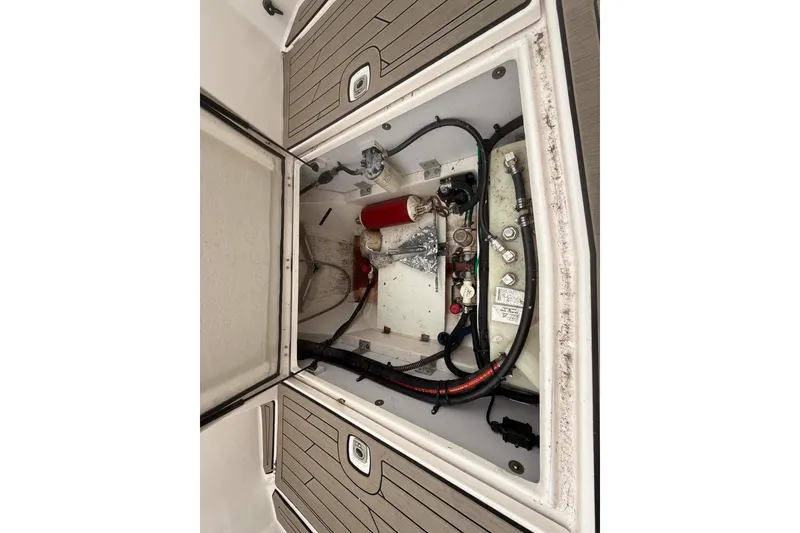 Slide: The Image of Engine compartment of a 2022 Cutwater C-24 Coupe boat, showing mechanical components and wiring. - 52
