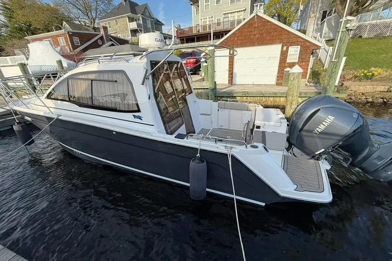 Slide: The Image of 2022 Cutwater C-24 Coupe boat docked with Yamaha engine. - 6