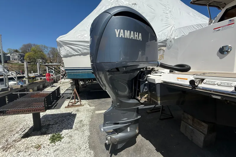 Slide: The Image of Yamaha outboard motor on a 2022 Cutwater C-24 Coupe boat at a marina. - 60