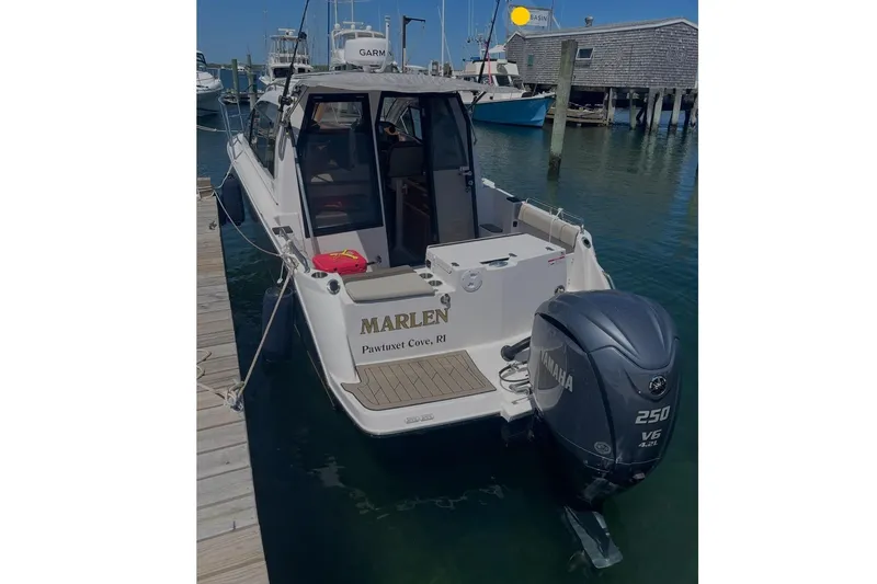 Slide: The Image of 2022 Cutwater C-24 Coupe boat docked at harbor. - 7