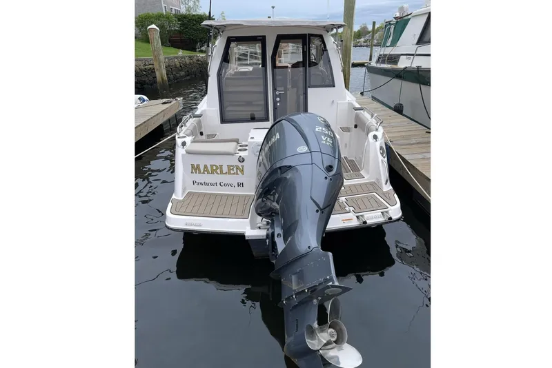 Slide: The Image of Rear view of a 2022 Cutwater C-24 Coupe boat in harbor. - 8