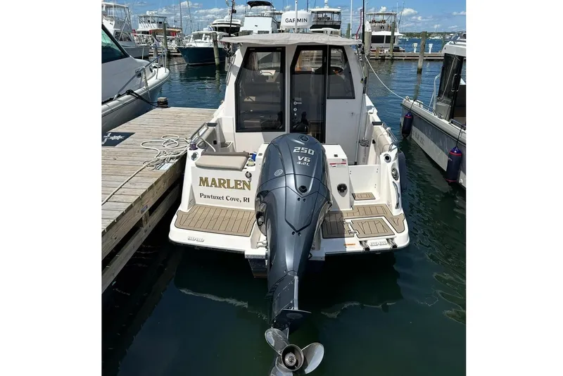 Slide: The Image of 2022 Cutwater C-24 Coupe docked with outboard motor. - 9