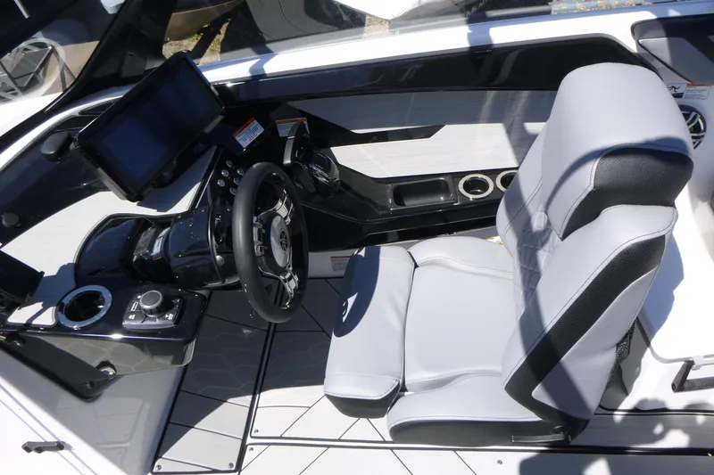 Slide: The Image of Interior of 2026 Yamaha Boats 222XD, featuring modern steering and comfortable seating. - 11