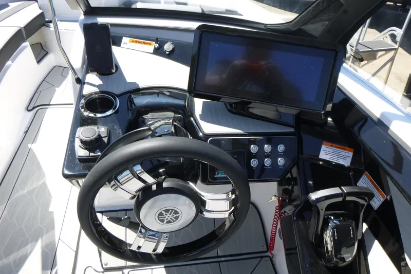 Slide: The Image of Cockpit of 2026 Yamaha Boats 222XD featuring steering wheel and digital display. - 12