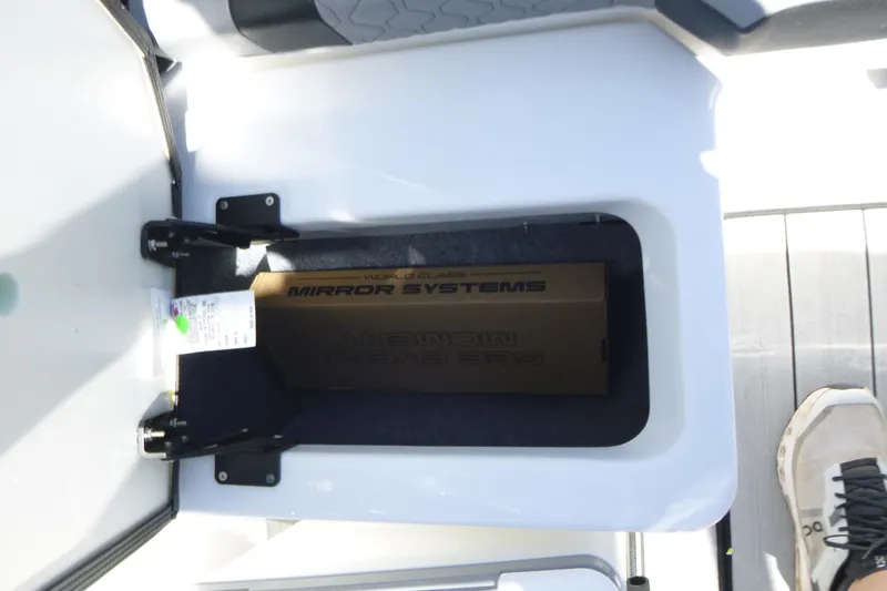 Slide: The Image of Storage compartment in 2026 Yamaha Boats 222XD, featuring a mirror systems box. - 15