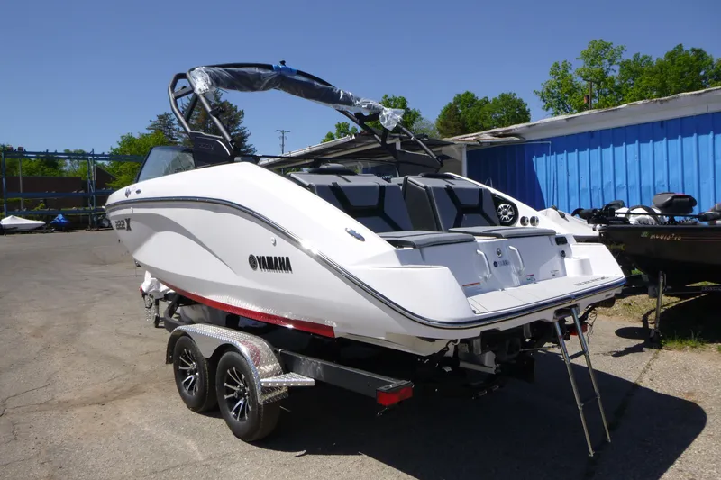 Slide: The Image of 2026 Yamaha Boats 222XD on trailer, sleek design, parked outdoors. - 3