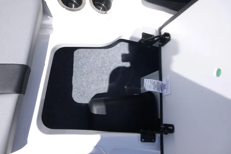 Slide: The Image of Interior detail of 2026 Yamaha Boats 222XD, featuring storage compartment and cup holders. - 8