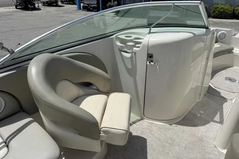 Slide: The Image of 2005 Sea Ray 220 Sundeck interior with seating and console, showcasing elegant design. - 13