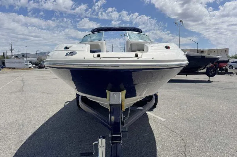 Slide: The Image of 2005 Sea Ray 220 Sundeck boat on trailer under a partly cloudy sky. - 14