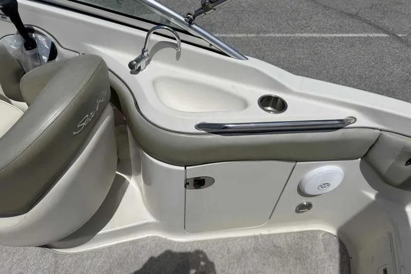 Slide: The Image of 2005 Sea Ray 220 Sundeck interior with seating, sink, and storage compartment. - 15