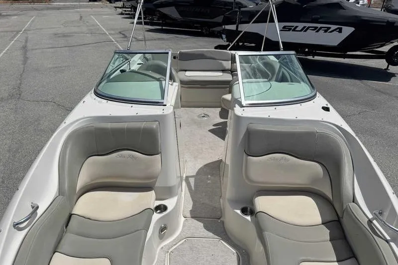 Slide: The Image of 2005 Sea Ray 220 Sundeck boat interior with spacious seating and windshield. - 17