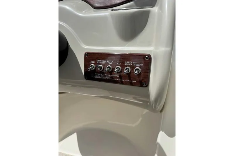 Slide: The Image of Control panel of a 2005 Sea Ray 220 Sundeck boat with labeled switches. - 19