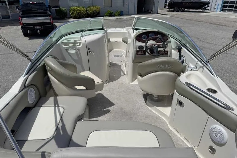 Slide: The Image of 2005 Sea Ray 220 Sundeck interior with seating and steering console. - 4