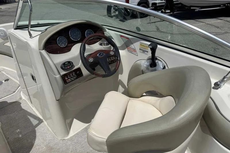 Slide: The Image of 2005 Sea Ray 220 Sundeck boat interior with steering wheel and dashboard controls. - 6