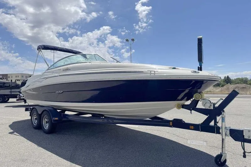 Slide: The Image of 2005 Sea Ray 220 Sundeck boat on trailer under a clear blue sky. - 7