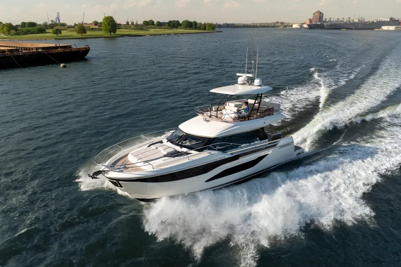 Slide: The Image of Luxurious 2025 Prestige F4.9 yacht cruising on a scenic waterway. - 12