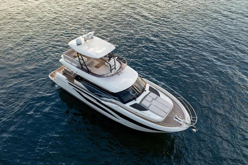 Slide: The Image of Luxurious 2025 Prestige F4.9 yacht cruising on open water, aerial view. - 13
