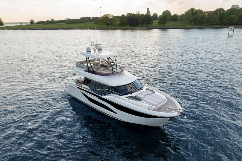 Slide: The Image of Luxury Prestige F4.9 yacht cruising on serene waters, 2025 model. - 14