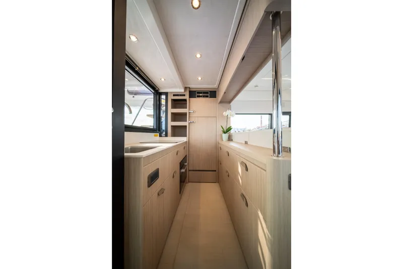 Slide: The Image of Modern kitchen interior of 2025 Prestige F4.9 yacht with sleek cabinetry and natural lighting. - 17