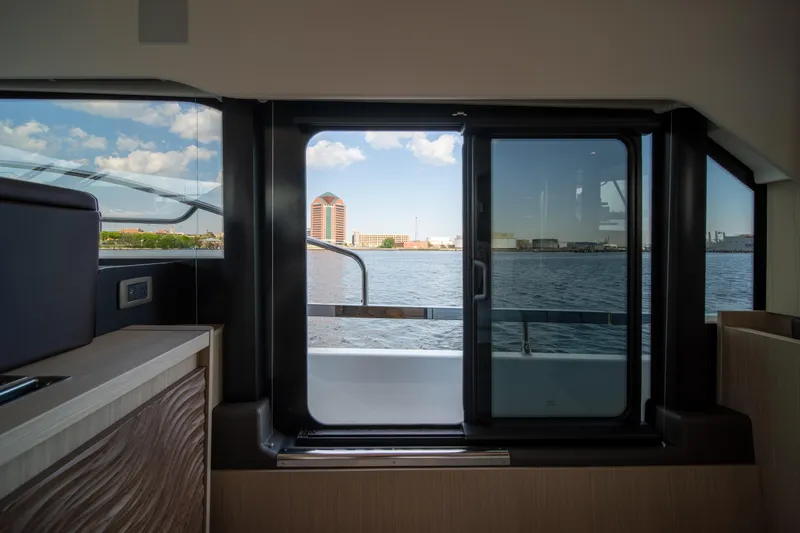 Slide: The Image of Interior view from Prestige F4.9 yacht, showcasing waterfront cityscape through large windows. - 21