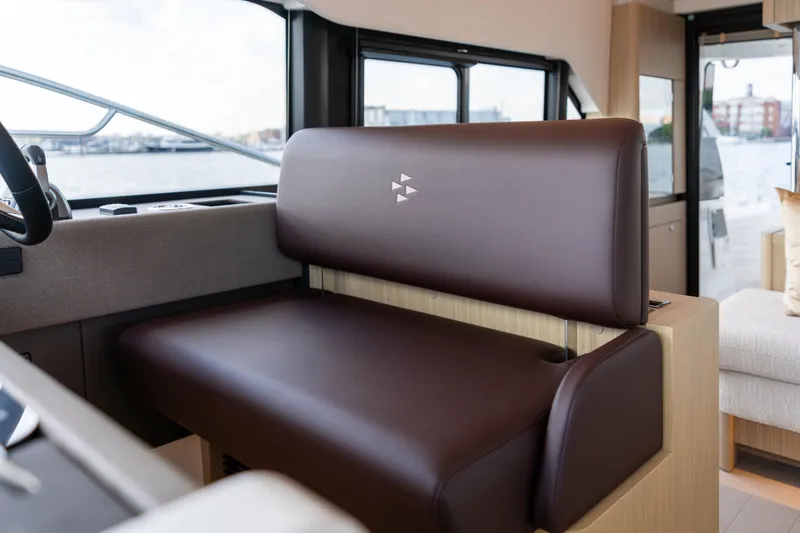 Slide: The Image of Luxurious interior seating of the 2025 Prestige F4.9 yacht with brown leather upholstery. - 23