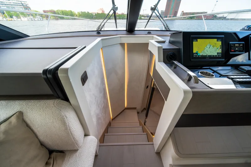 Slide: The Image of Modern interior of 2025 Prestige F4.9 yacht with navigation system and sleek staircase. - 27