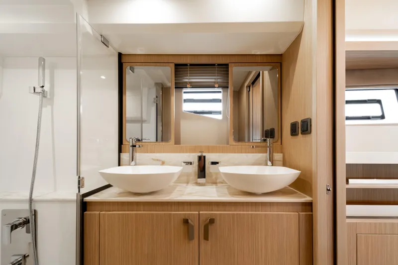 Slide: The Image of Modern bathroom interior in Prestige F4.9 yacht, featuring dual sinks and sleek design, 2025 model. - 32