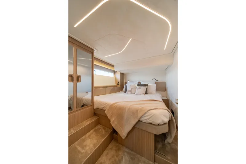 Slide: The Image of Luxurious bedroom interior of 2025 Prestige F4.9 yacht with modern lighting and cozy bedding. - 35
