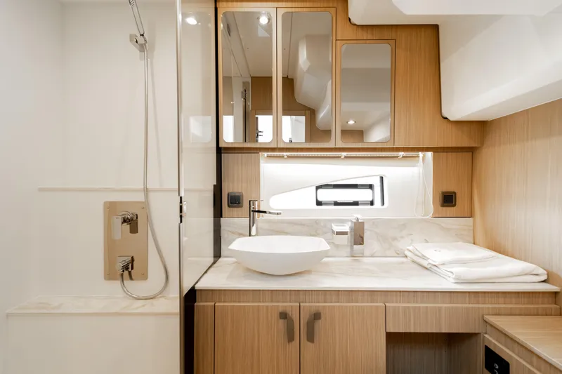 Slide: The Image of Luxurious bathroom in 2025 Prestige F4.9 yacht with modern fixtures and wooden cabinetry. - 36