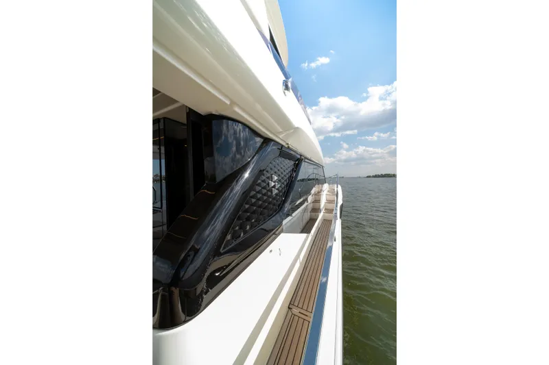 Slide: The Image of Side view of 2025 Prestige F4.9 yacht on open water under blue sky. - 46