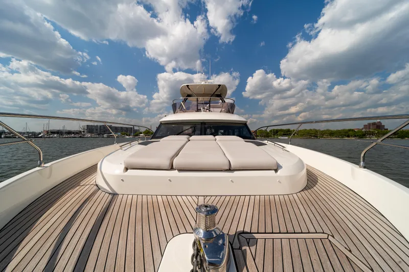 Slide: The Image of Luxurious 2025 Prestige F4.9 yacht deck with sun loungers under a vibrant sky. - 47