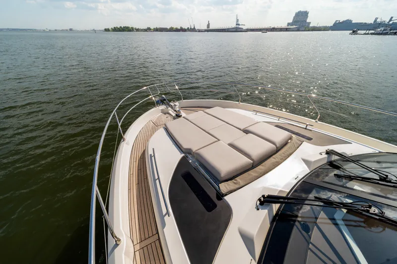 Slide: The Image of Prestige F4.9 yacht deck, 2025 model, cruising on calm waters under a clear sky. - 49