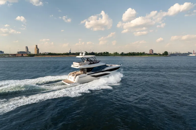 Slide: The Image of Luxury yacht Prestige F4.9 cruising on open water, 2025 model, under a clear sky. - 5