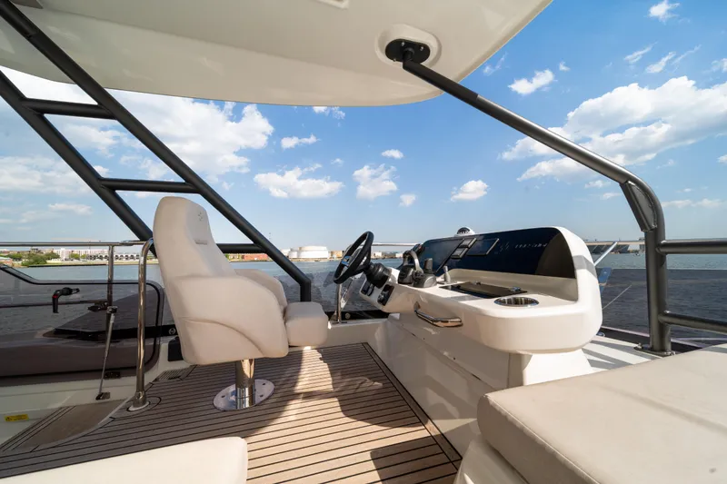 Slide: The Image of Luxurious Prestige F4.9 yacht helm with modern controls, overlooking serene waters, 2025 model. - 52
