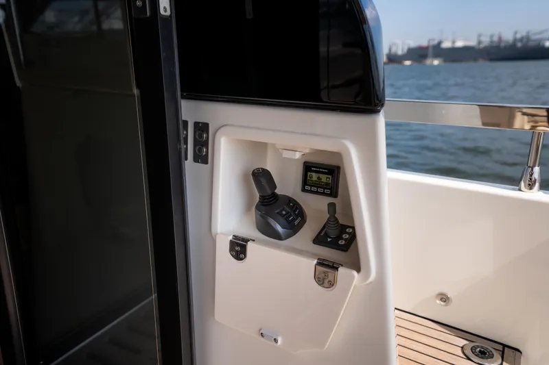 Slide: The Image of Control panel of Prestige F4.9 yacht, 2025 model, overlooking the water. - 53