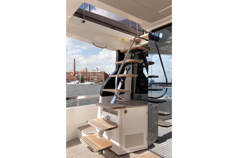 Slide: The Image of Modern yacht staircase on Prestige F4.9, 2025 model, with waterfront view. - 54