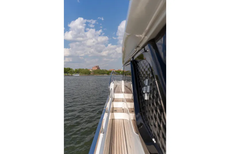 Slide: The Image of Side view of Prestige F4.9 yacht, 2025 model, cruising on a sunny day. - 55