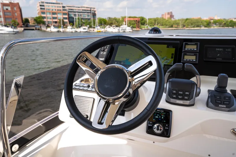 Slide: The Image of Prestige F4.9 2025 boat dashboard with steering wheel and navigation controls. - 58