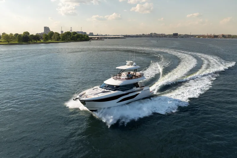 Slide: The Image of Luxurious 2025 Prestige F4.9 yacht cruising on a scenic waterway. - 8