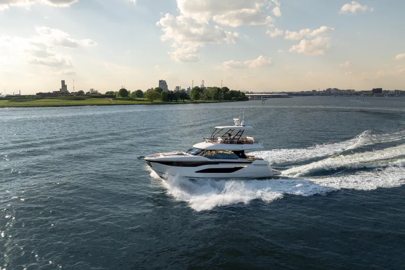 Slide: The Image of Luxury Prestige F4.9 yacht cruising on open water, 2025 model. - 9