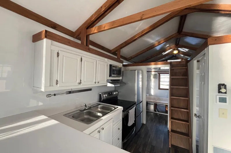 Slide: The Image of Interior of 2017 Catamaran Cruisers Aqualodge with kitchen, wooden beams, and loft ladder. - 10