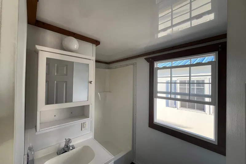 Slide: The Image of Bathroom interior of 2017 Catamaran Cruisers Aqualodge with window and mirror cabinet. - 11
