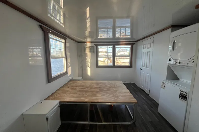 Slide: The Image of Interior of 2017 Catamaran Cruisers Aqualodge with table, windows, and stacked washer-dryer. - 12