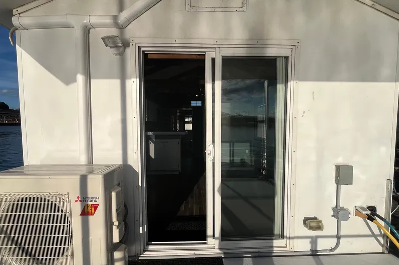 Slide: The Image of 2017 Catamaran Cruisers Aqualodge with sliding glass door and exterior air conditioning unit. - 19