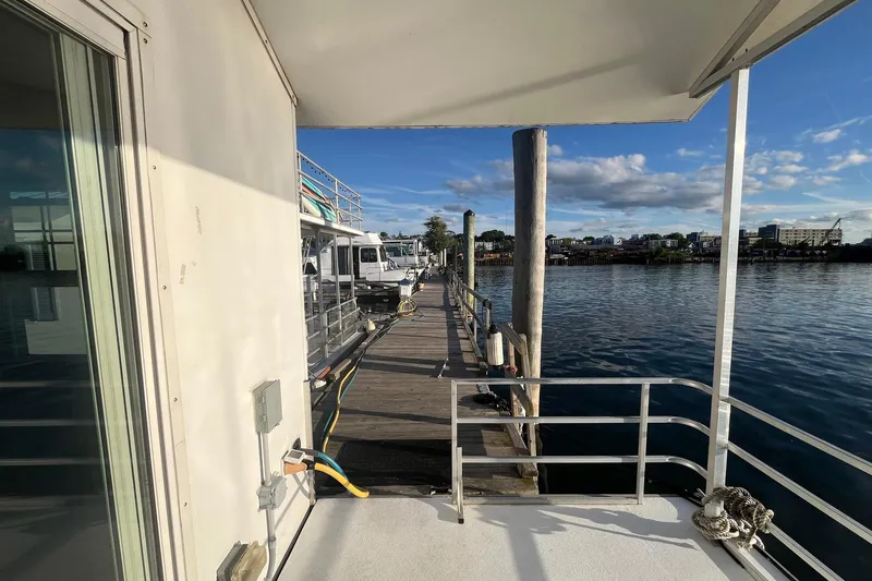 Slide: The Image of 2017 Catamaran Cruisers Aqualodge docked by a serene waterfront under a clear blue sky. - 20
