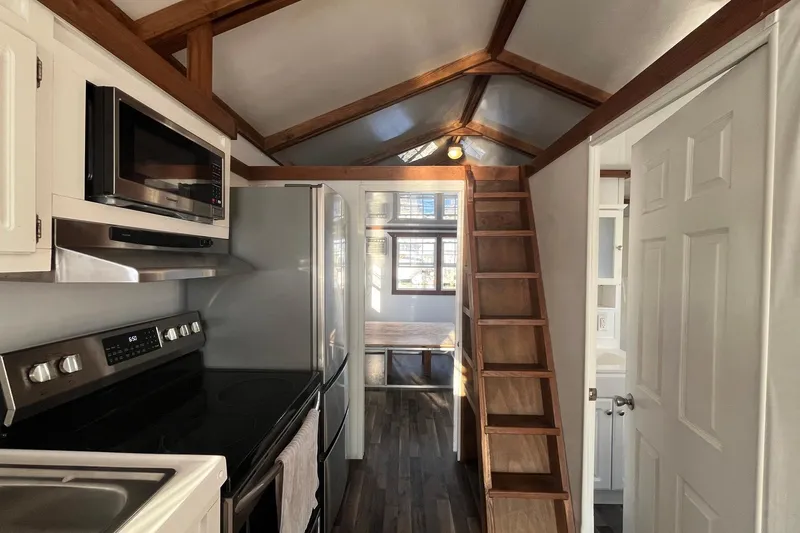 Slide: The Image of Interior of 2017 Catamaran Cruisers Aqualodge with kitchen and wooden loft ladder. - 23