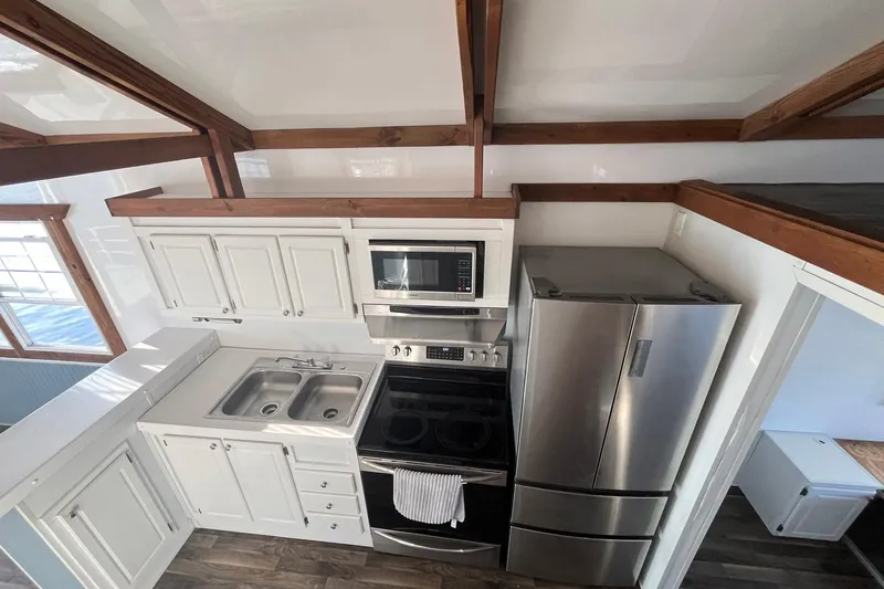 Slide: The Image of Modern kitchen in 2017 Catamaran Cruisers Aqualodge with stainless steel appliances and wooden beams. - 25